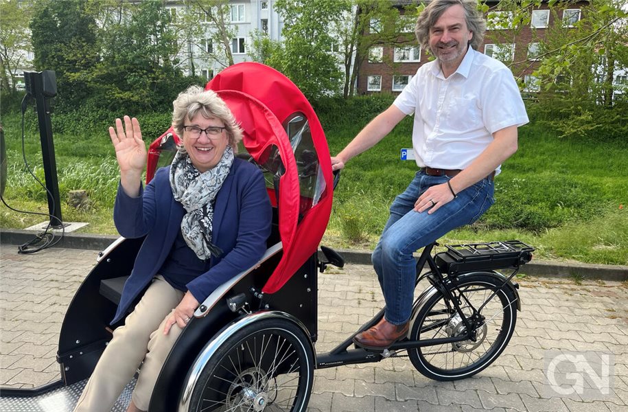 David Korte als Vertreter für die geldgebende GMP-Stiftung und Ingrid Thole als Vorsitzende der Freiwilligenagentur auf der neuen Rikscha, die jetzt bewegungsbeeinträchttigte Menschen durch Nordhorn fährt.